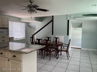 1034 Bali Road Cocoa Beach, FL 32931 - Photo 10 of 40 a kitchen with a table and chairs