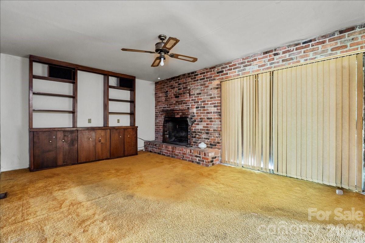 1444 Society Hill Road Darlington, SC 29540 - Photo 14 of 35 a view of an empty room with a fireplace and a window