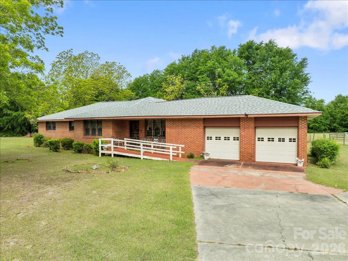 1444 Society Hill Road Darlington, SC 29540 - Photo 2 of 35 a front view of a house with a yard garage and outdoor seating