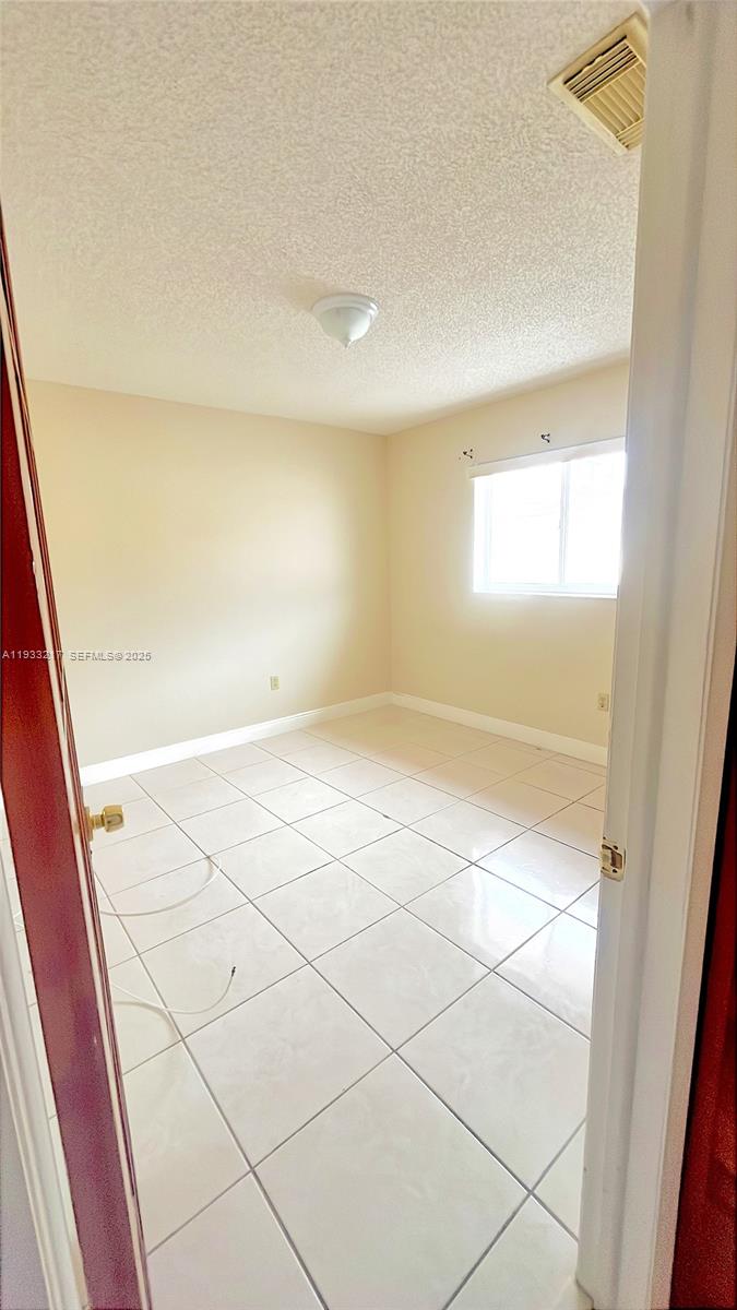 2220 West 74th Street, Unit 20116 Hialeah, FL 33016 - Photo 15 of 23 a view of an empty room and a window