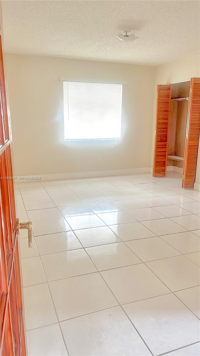2220 West 74th Street, Unit 20116 Hialeah, FL 33016 - Photo 23 of 23 a view of an empty room with window
