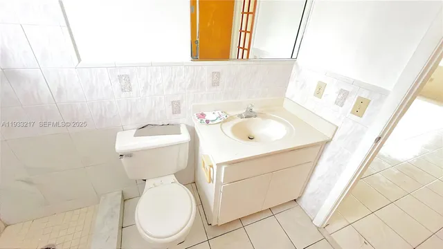 a bathroom with a sink toilet and mirror