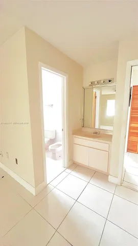 a bathroom with a tub shower and sink