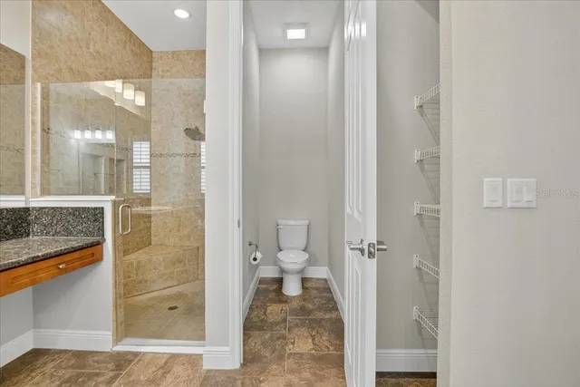 a bathroom with a glass door shower
