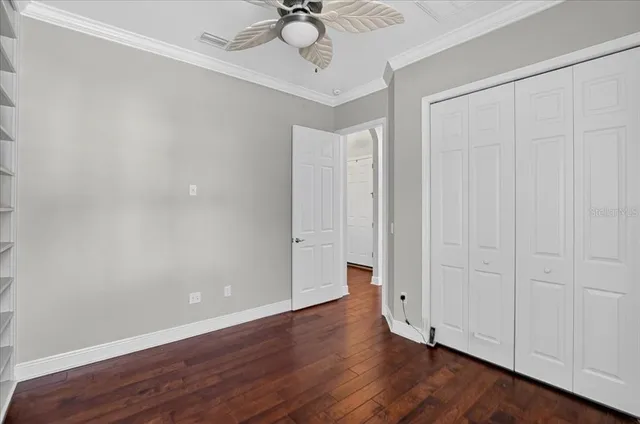 a view of an empty room with wooden floor