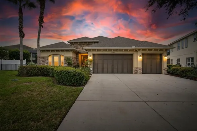 a front view of a house with a yard and garage
