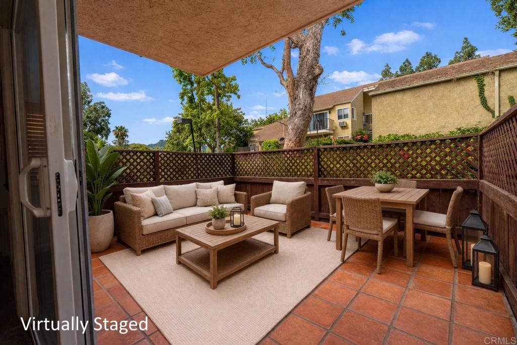 1145 Helix Street, Unit 13 Spring Valley, CA 91977 - Photo 2 of 12 a view of a patio with couches and table and chairs with wooden fence