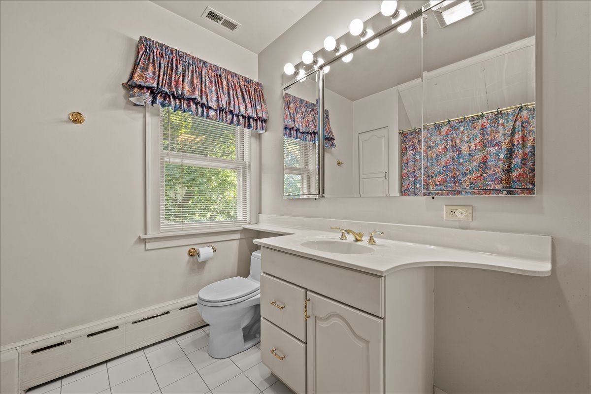 27 Logan Terrace Golf, IL 60029 - Photo 18 of 30 a bathroom with a sink a vanity and a mirror