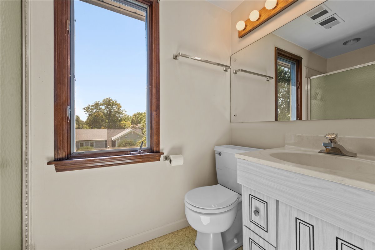 27 Logan Terrace Golf, IL 60029 - Photo 21 of 30 a bathroom with a sink a toilet and a mirror