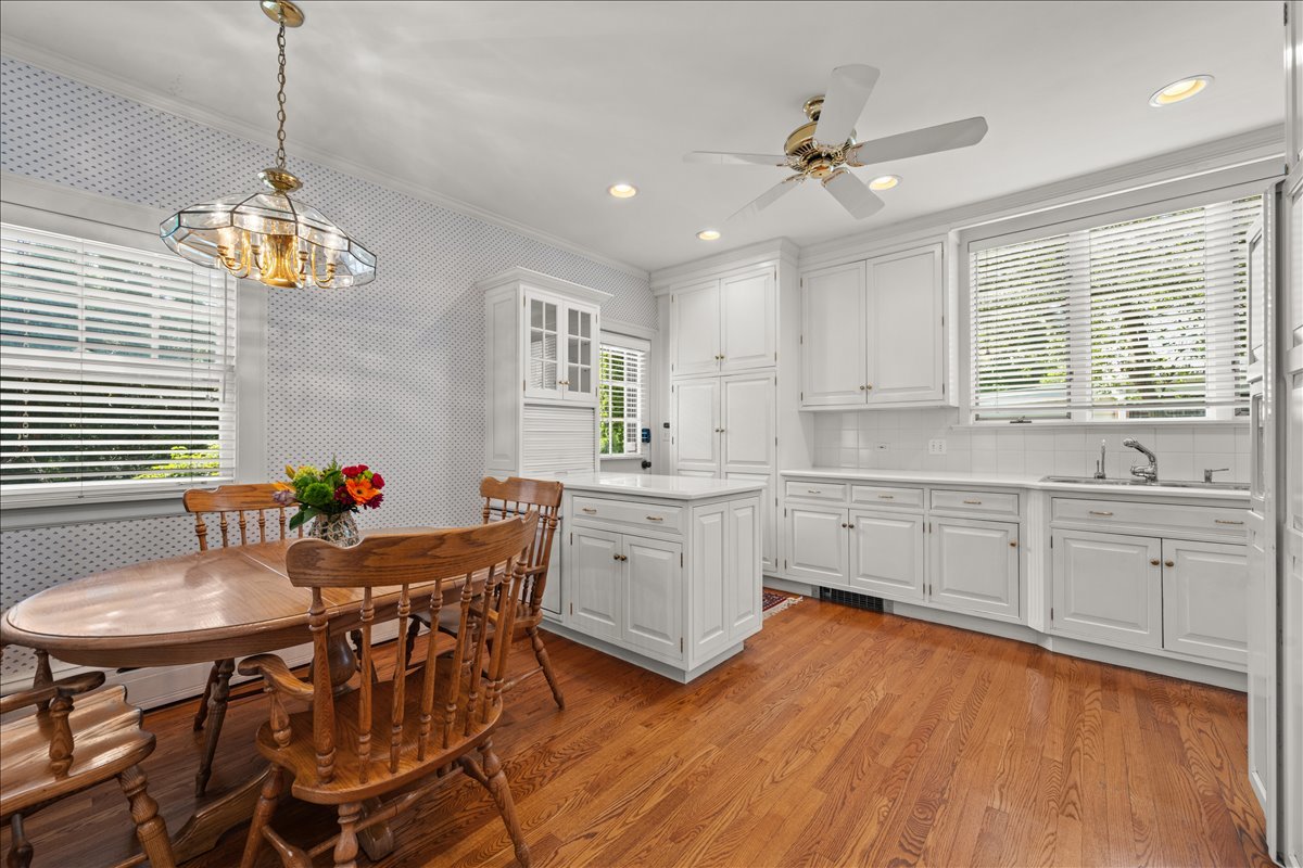 27 Logan Terrace Golf, IL 60029 - Photo 9 of 30 a kitchen with sink refrigerator cabinets and dining table