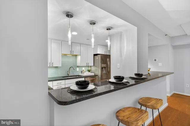 a kitchen with a table and chairs in it