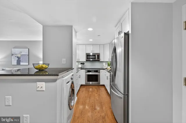 a kitchen with stainless steel appliances granite countertop a stove and a refrigerator