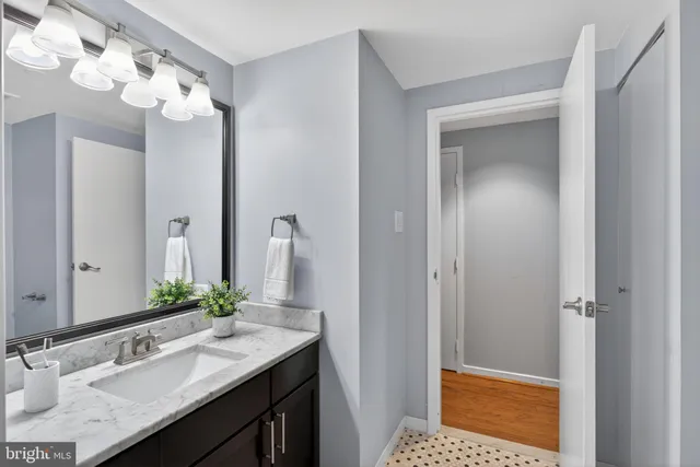 a bathroom with a sink vanity and a mirror