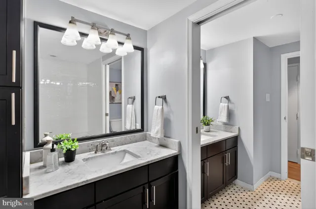 a bathroom with a sink a vanity and a mirror