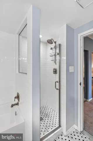 a bathroom with a bathtub and shower