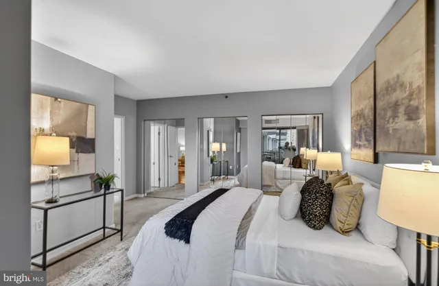 a bedroom with a bed and large windows