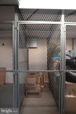 a living room with large couches and kitchen view