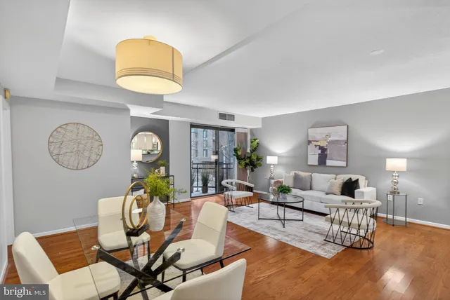 a living room with furniture a rug and a window