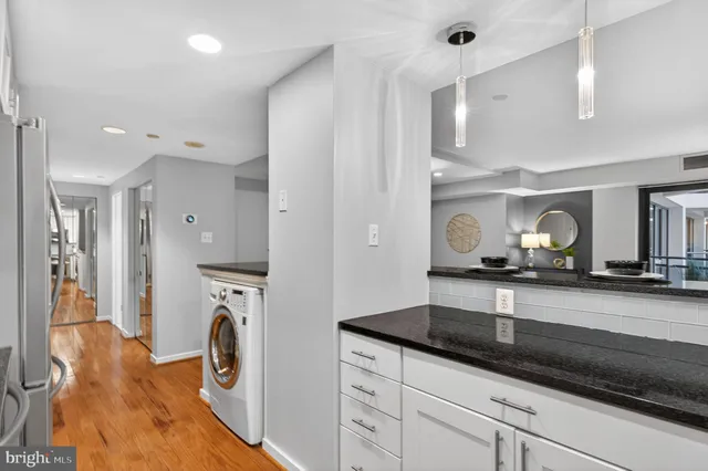 a kitchen with refrigerator and cabinets