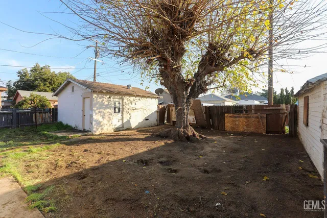 a bedroom with a bed a dresser and a window