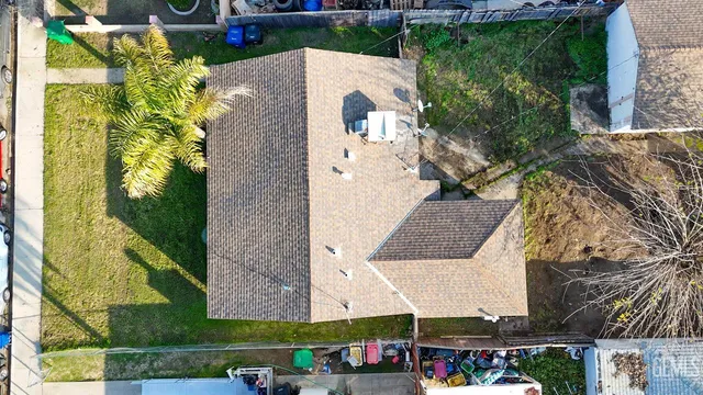 an aerial view of a house with a yard
