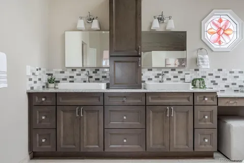 a bathroom with a sink vanity and a mirror