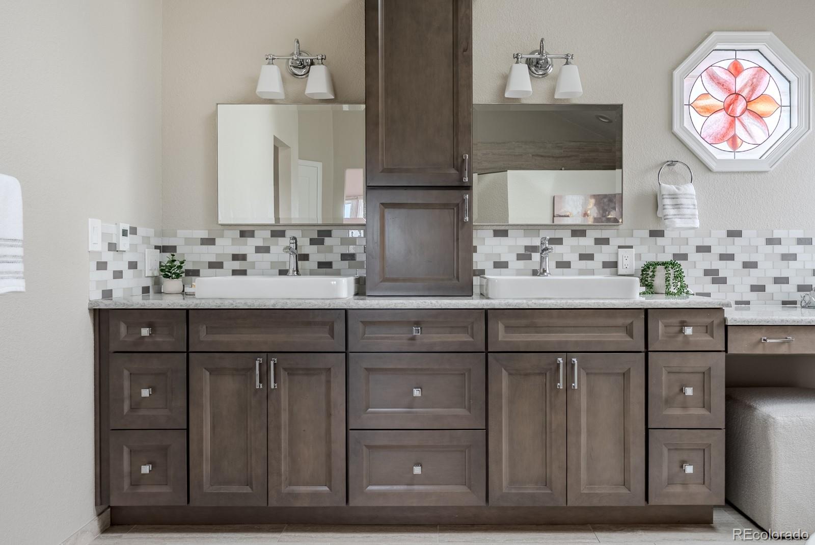 1914 Terrace Drive Highlands Ranch, CO 80126 - Photo 22 of 47 a bathroom with a sink vanity and a mirror