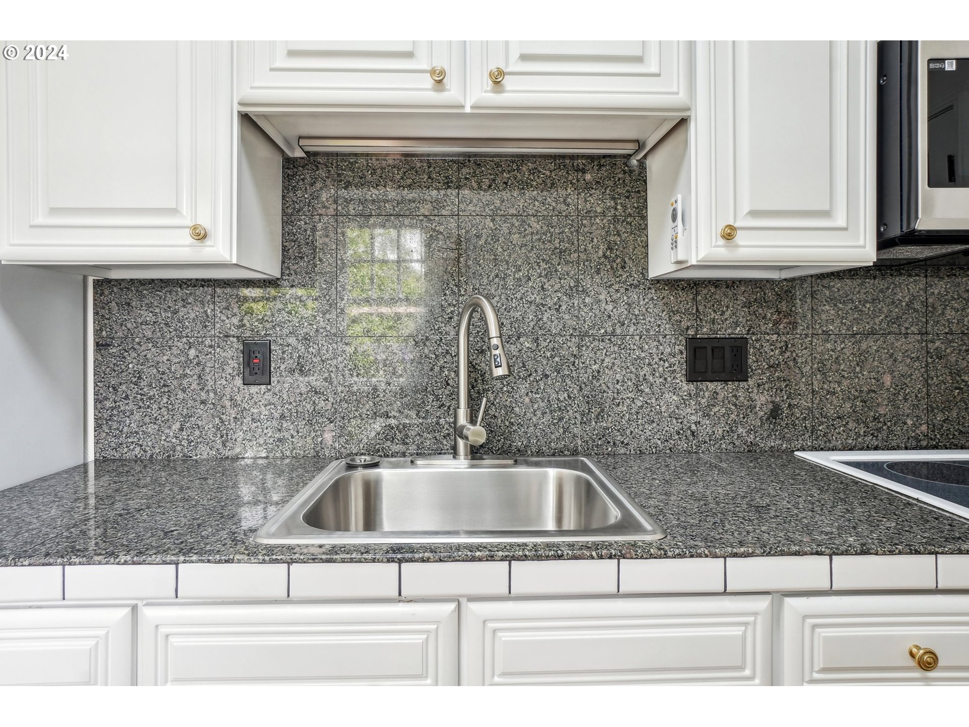 1510 Northeast 19th Avenue, Unit 4 Portland, OR 97232 - Photo 12 of 39 a close view of a sink and granite counter top