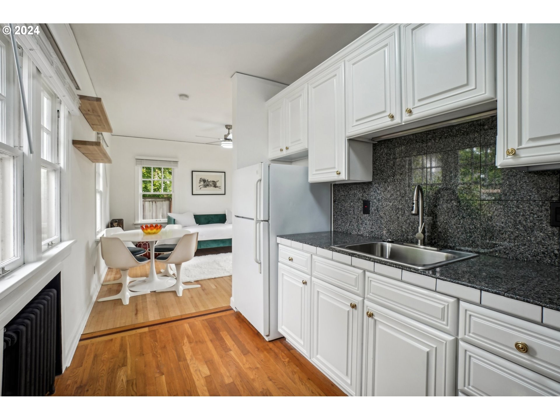 1510 Northeast 19th Avenue, Unit 4 Portland, OR 97232 - Photo 13 of 39 a open kitchen with granite countertop a sink and cabinets