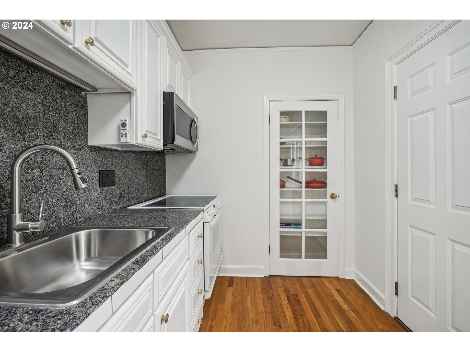 1510 Northeast 19th Avenue, Unit 4 Portland, OR 97232 - Photo 15 of 39 a kitchen with a sink a stove and cabinets