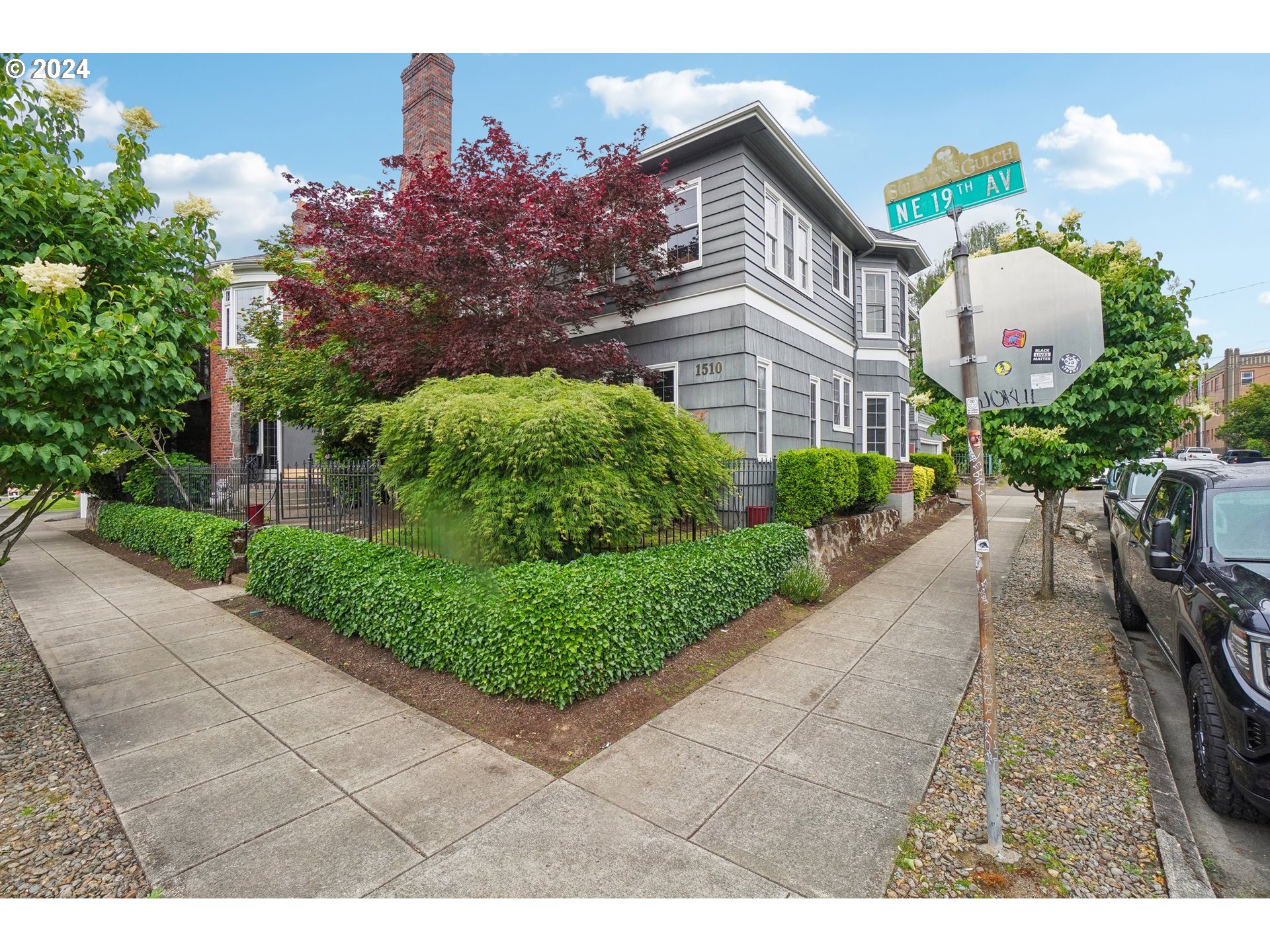 1510 Northeast 19th Avenue, Unit 4 Portland, OR 97232 - Photo 2 of 39 a front view of a house with a yard and potted plants