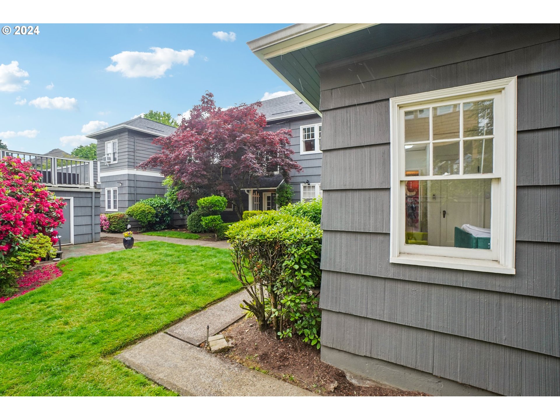 1510 Northeast 19th Avenue, Unit 4 Portland, OR 97232 - Photo 23 of 39 a view of a house with a garden