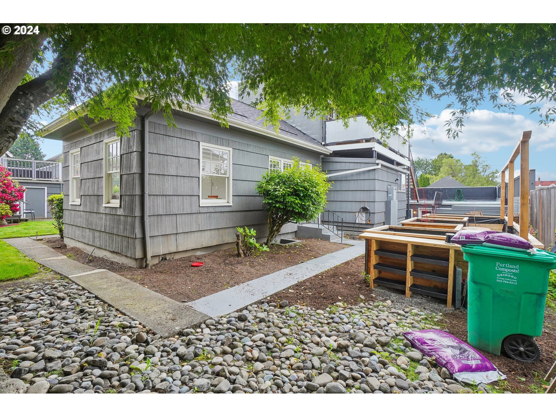 1510 Northeast 19th Avenue, Unit 4 Portland, OR 97232 - Photo 24 of 39 a backyard of a house with a garden