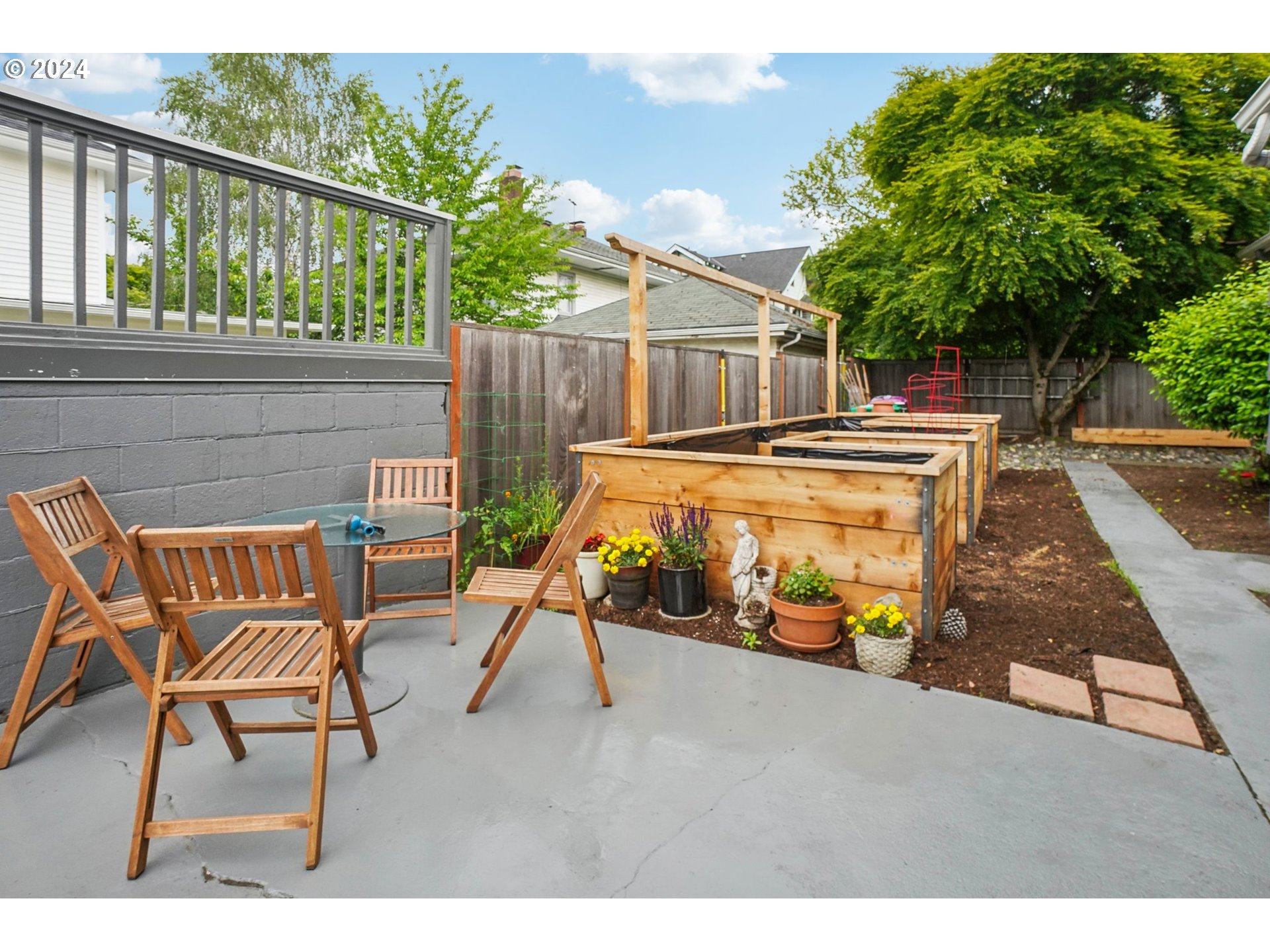 1510 Northeast 19th Avenue, Unit 4 Portland, OR 97232 - Photo 25 of 39 a backyard of a house with table and chairs