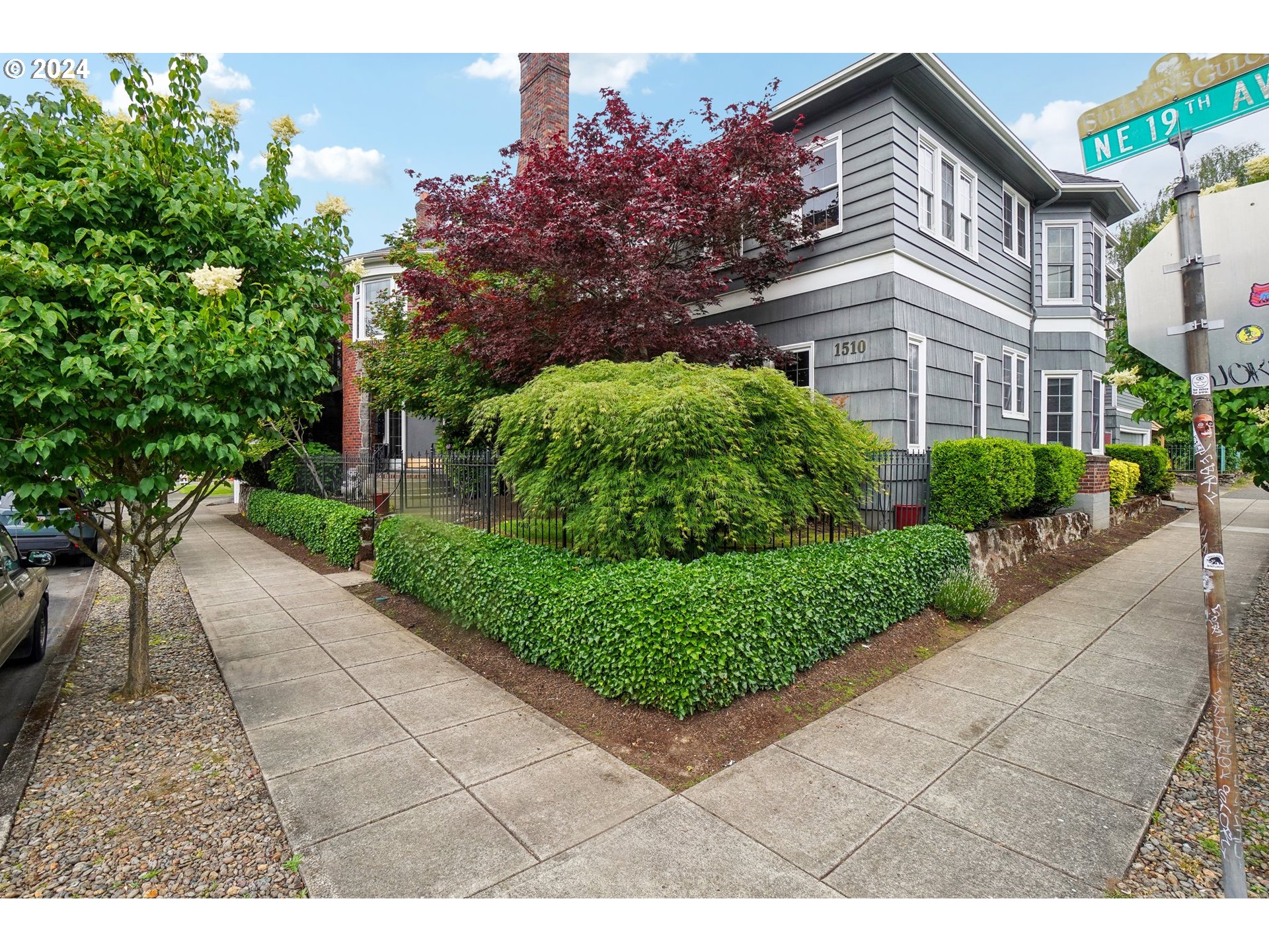 1510 Northeast 19th Avenue, Unit 4 Portland, OR 97232 - Photo 4 of 39 a view of a street with a large trees