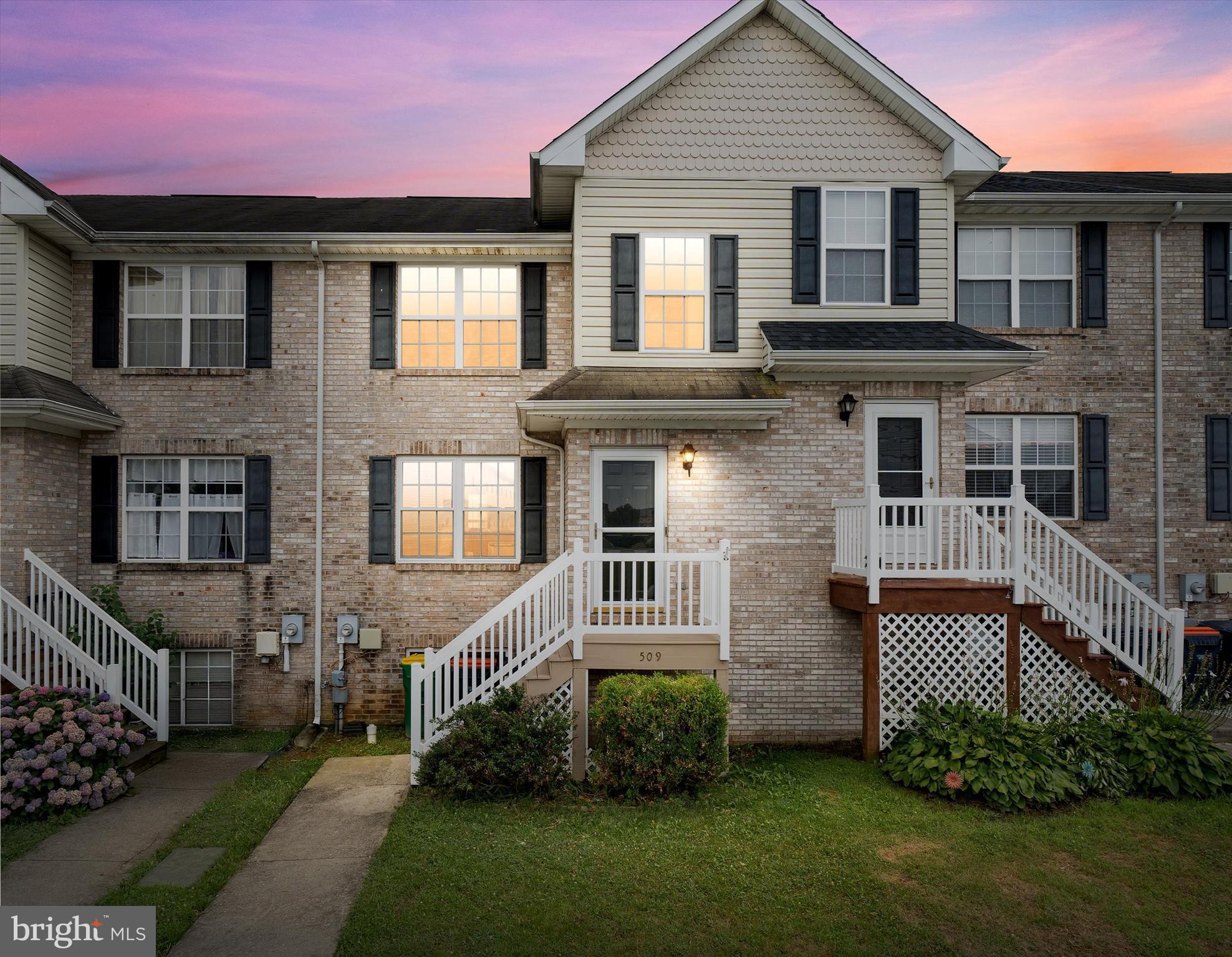 a front view of a house with a garden