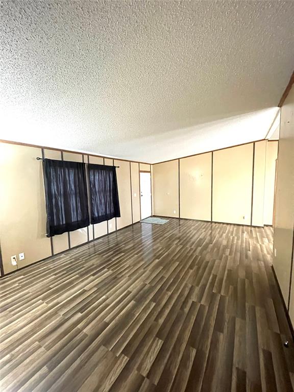 440 Ballman Road Riesel, TX 76682 - Photo 13 of 32 an empty room with wooden floor and windows