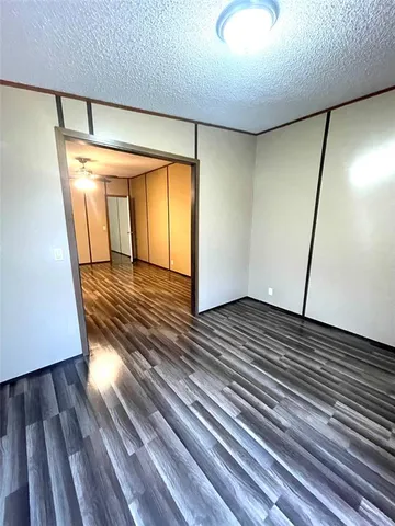 a view of a room with wooden floor
