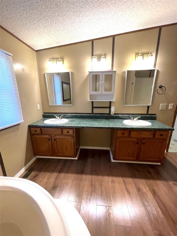440 Ballman Road Riesel, TX 76682 - Photo 21 of 32 a bathroom with double vanity and a mirror
