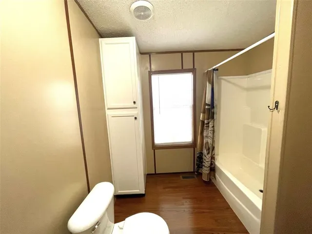 a bathroom with a shower and a toilet