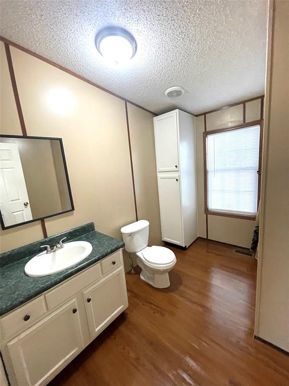 440 Ballman Road Riesel, TX 76682 - Photo 23 of 32 a bathroom with a double vanity sink toilet and a mirror