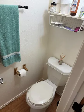 a white toilet sitting next to a bathroom sink