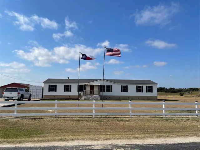 a view of house with yard and entertaining space