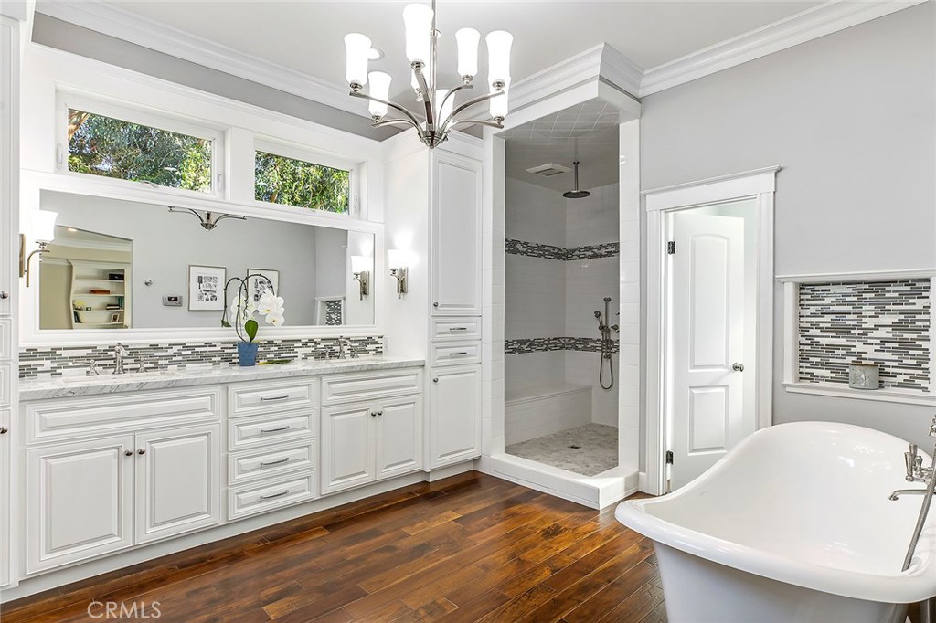 12822 Periwinkle Drive North Tustin, CA 92705 - Photo 21 of 36 a spacious bathroom with a granite countertop sink mirror and a shower