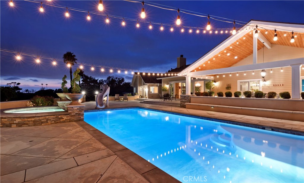 12822 Periwinkle Drive North Tustin, CA 92705 - Photo 28 of 36 a view of a swimming pool with an outdoor seating
