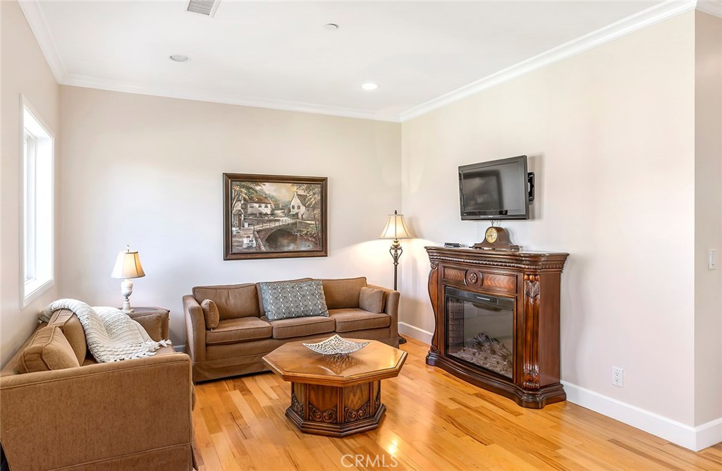 12822 Periwinkle Drive North Tustin, CA 92705 - Photo 34 of 36 a living room with furniture and a fireplace