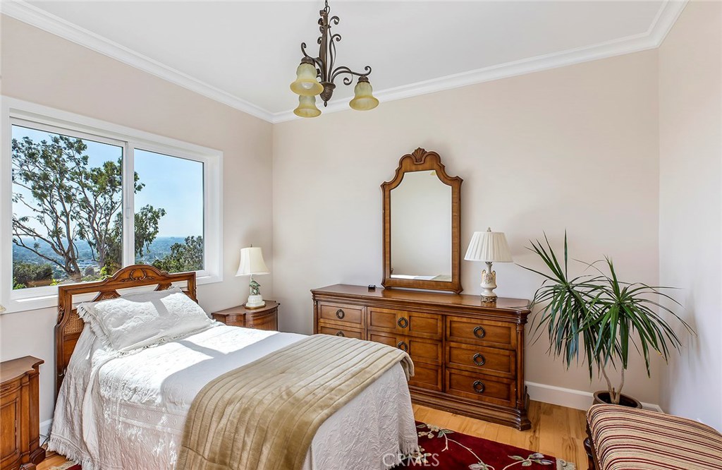 12822 Periwinkle Drive North Tustin, CA 92705 - Photo 36 of 36 a bedroom with a bed and a chandelier