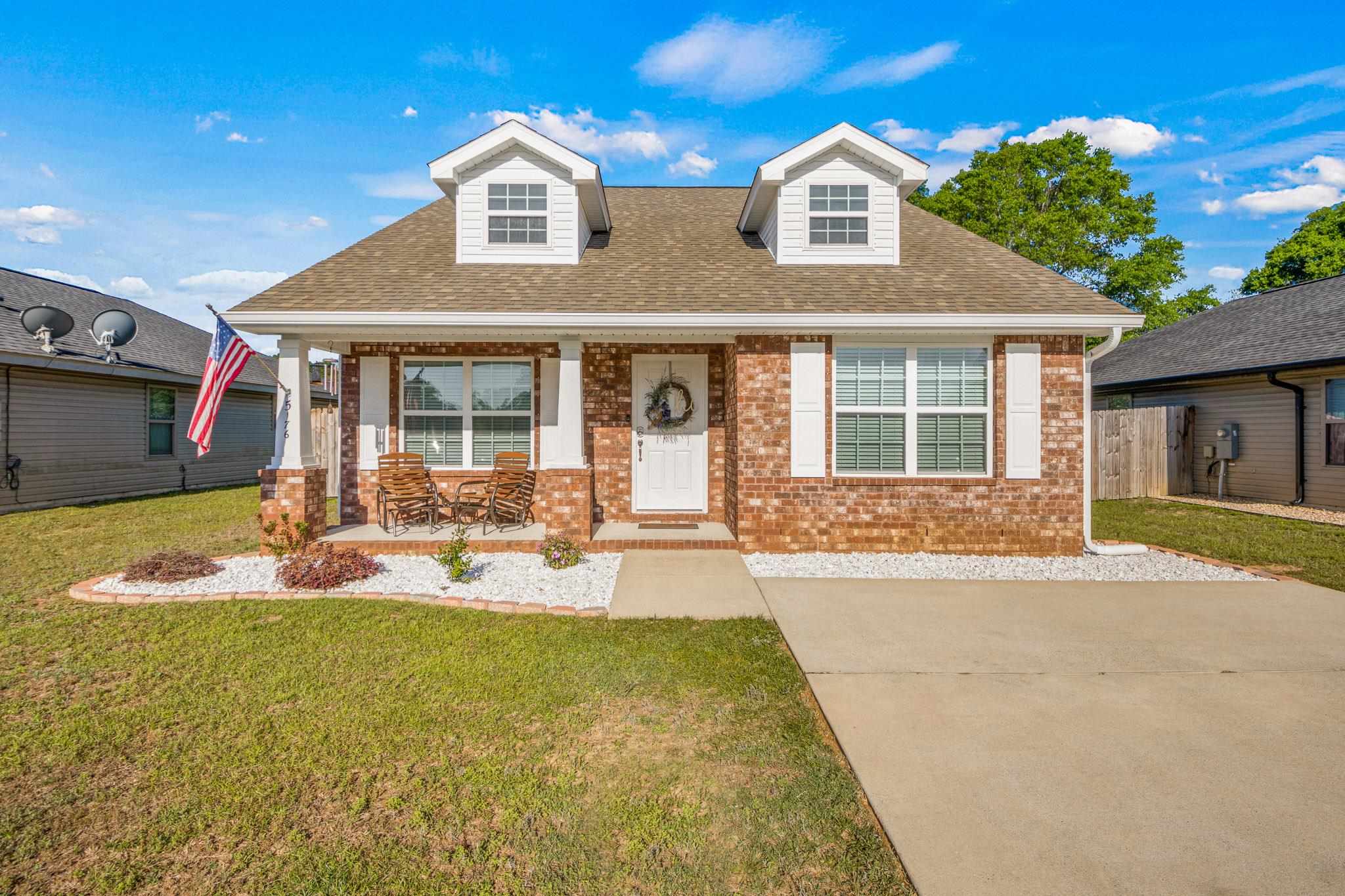 a view of house with yard outdoor seating and kitchen view