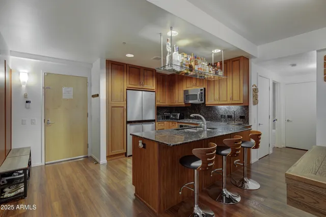 a kitchen with a table and refrigerator in it