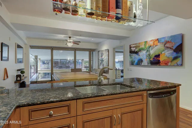 a kitchen with stainless steel appliances granite countertop a sink and a counter space